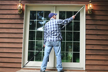 Man Using Squaring Pole on French Door